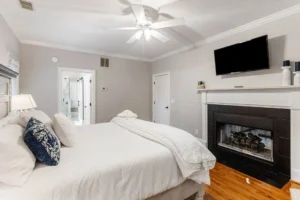 A bedroom with a fireplace and a bed