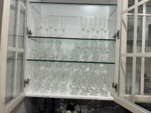 A cabinet with many glasses on it
