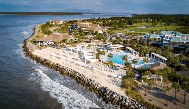image - 2025-03-28T061042.864 A beach with many swimming pools and water slides.