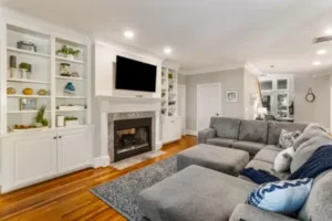 A living room with a fireplace and a large couch.