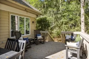 A deck with chairs and tables on it
