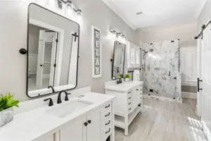 A bathroom with two sinks and a large mirror.