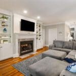 A living room with a fireplace and a large couch.